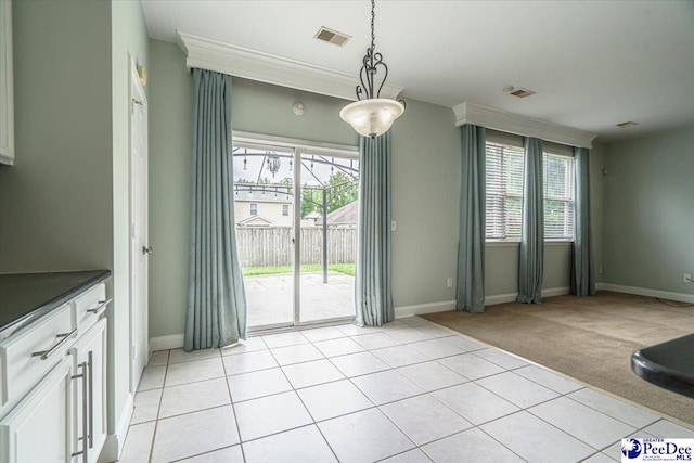 unfurnished dining area with light carpet and plenty of natural light