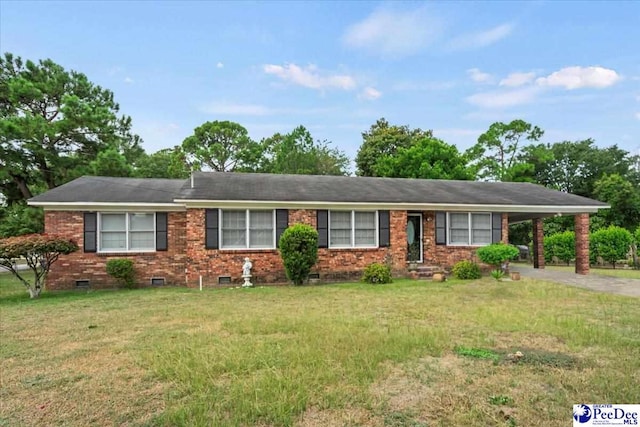 ranch-style house featuring a carport and a front lawn