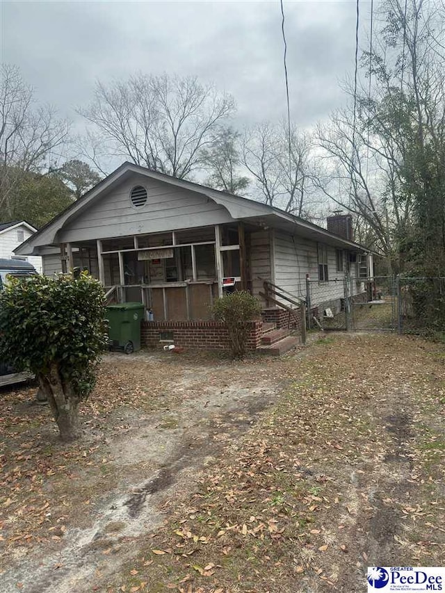 view of front of house with a sunroom