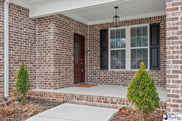 entrance to property featuring covered porch