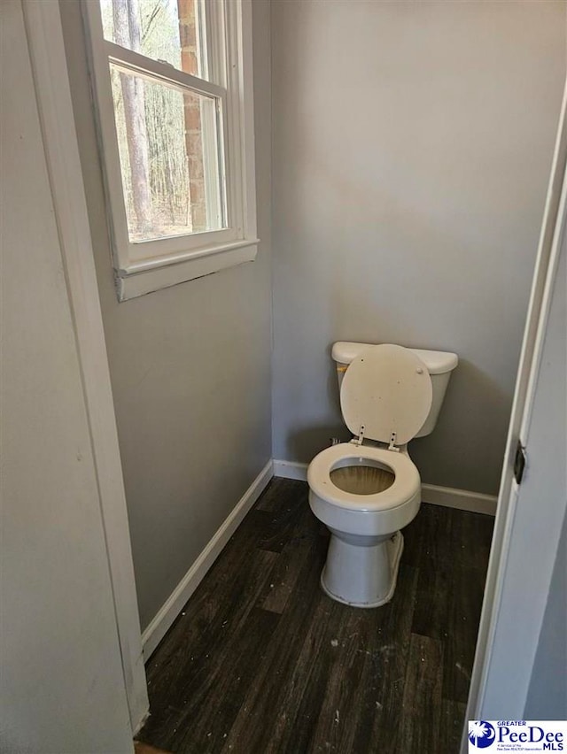 bathroom featuring baseboards, toilet, and wood finished floors