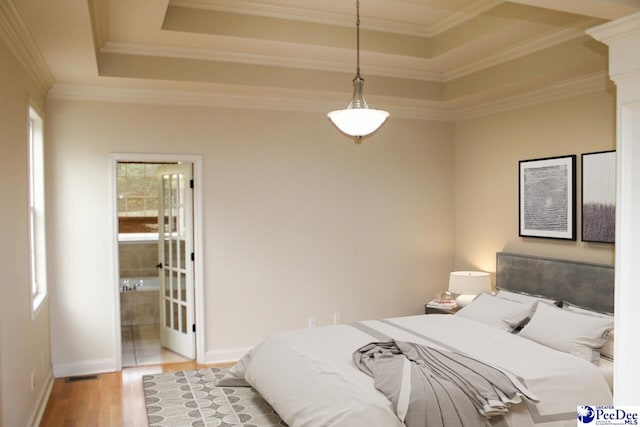 610 Garden Rose Ct, Greer, SC 29651 - bedroom with multiple windows, wood finished floors, a tray ceiling, crown molding, and connected bathroom