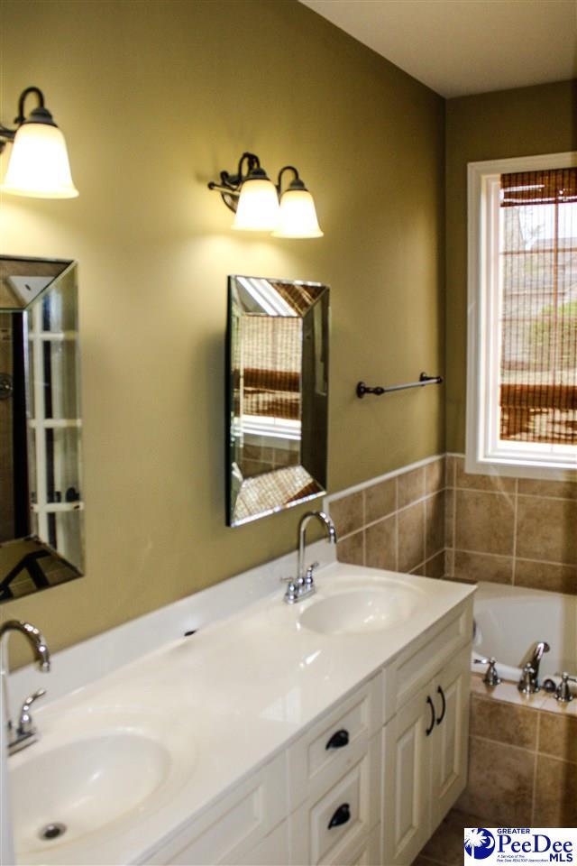 610 Garden Rose Ct, Greer, SC 29651 - bathroom with double vanity and a garden tub