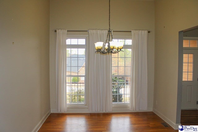 610 Garden Rose Ct, Greer, SC 29651 - unfurnished dining area with a chandelier, wood finished floors, and plenty of natural light