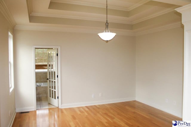 610 Garden Rose Ct, Greer, SC 29651 - empty room with wood finished floors, crown molding, and a raised ceiling