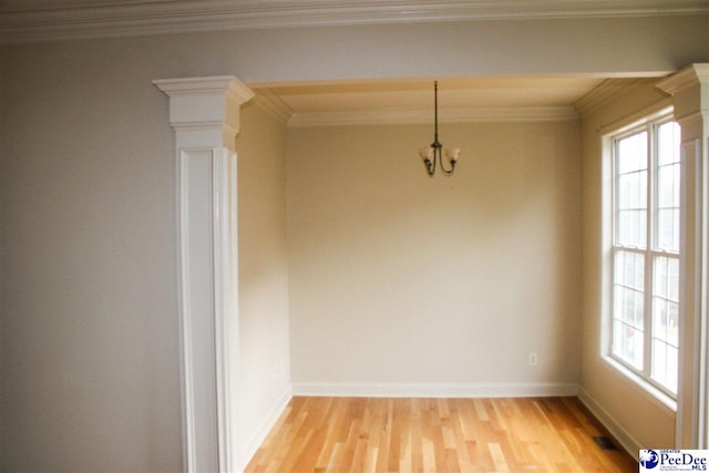610 Garden Rose Ct, Greer, SC 29651 - unfurnished dining area with plenty of natural light, light wood-style floors, decorative columns, ornamental molding, and a chandelier