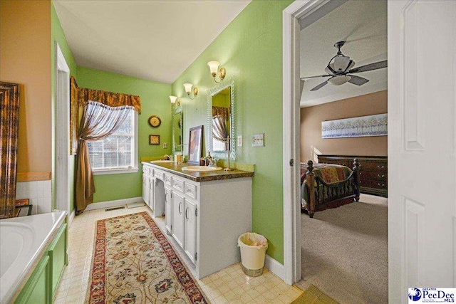 bathroom featuring vaulted ceiling, vanity, and ceiling fan