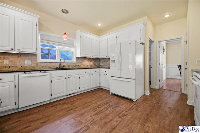 2819 Hermitage Ln, Florence, SC 29501 - kitchen featuring white appliances, a sink, dark countertops, dark wood finished floors, and white cabinetry