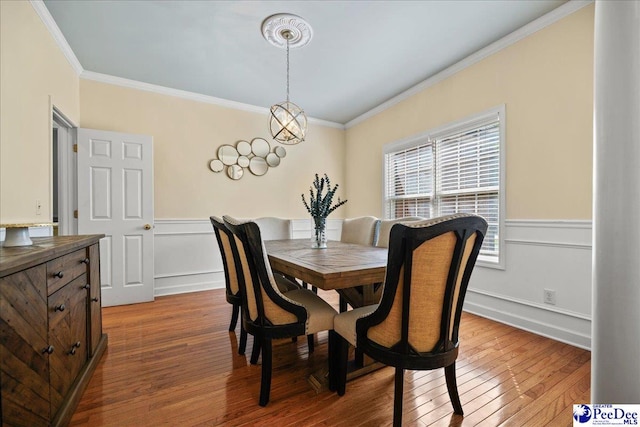 2819 Hermitage Ln, Florence, SC 29501 - dining area featuring crown molding, a wainscoted wall, wood finished floors, and a decorative wall