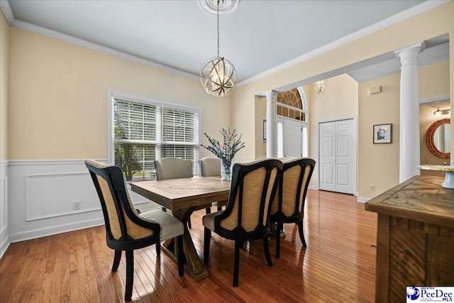 2819 Hermitage Ln, Florence, SC 29501 - dining area with a chandelier, decorative columns, wood finished floors, crown molding, and wainscoting