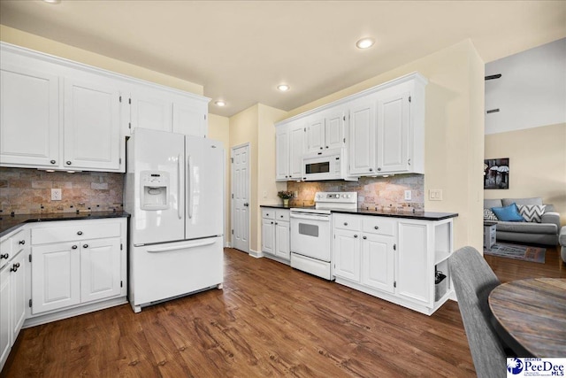 2819 Hermitage Ln, Florence, SC 29501 - kitchen with white appliances, dark countertops, dark wood-style flooring, white cabinets, and recessed lighting