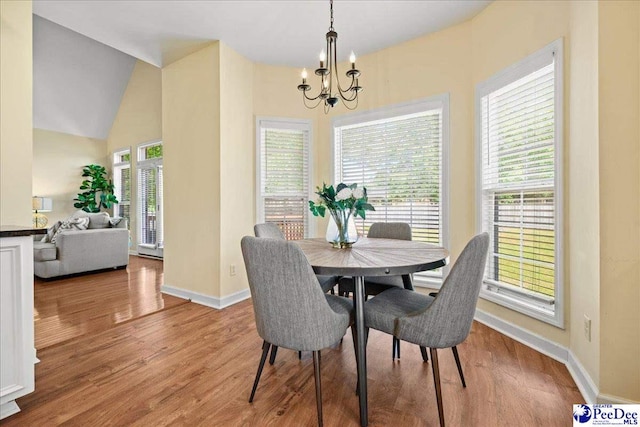 2819 Hermitage Ln, Florence, SC 29501 - dining area with a chandelier, baseboards, wood finished floors, and vaulted ceiling