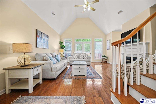 2819 Hermitage Ln, Florence, SC 29501 - living area featuring ceiling fan, hardwood / wood-style floors, baseboards, stairway, and high vaulted ceiling