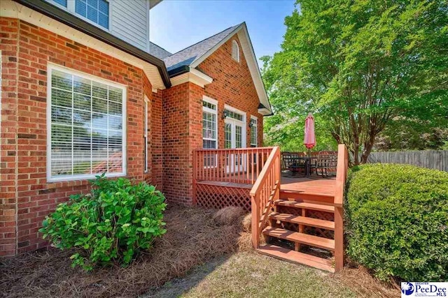 2819 Hermitage Ln, Florence, SC 29501 - property entrance featuring brick siding, a wooden deck, and fence