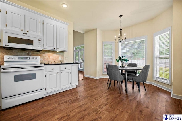 2819 Hermitage Ln, Florence, SC 29501 - kitchen with white appliances, a chandelier, baseboards, white cabinets, and recessed lighting
