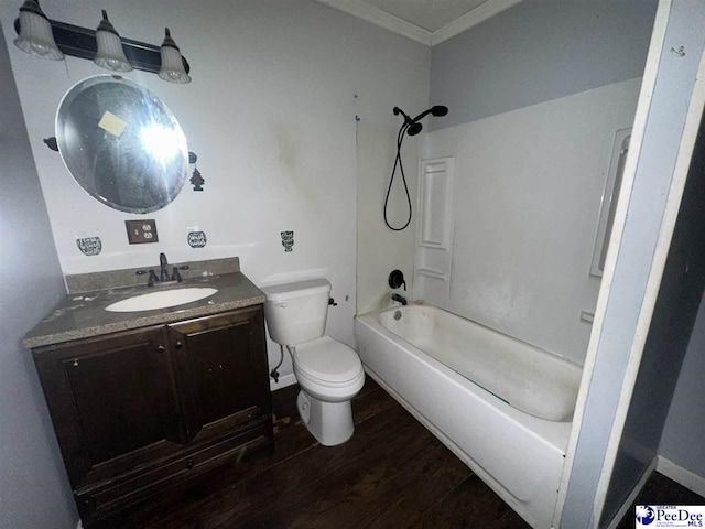 full bathroom with shower / washtub combination, hardwood / wood-style flooring, ornamental molding, vanity, and toilet