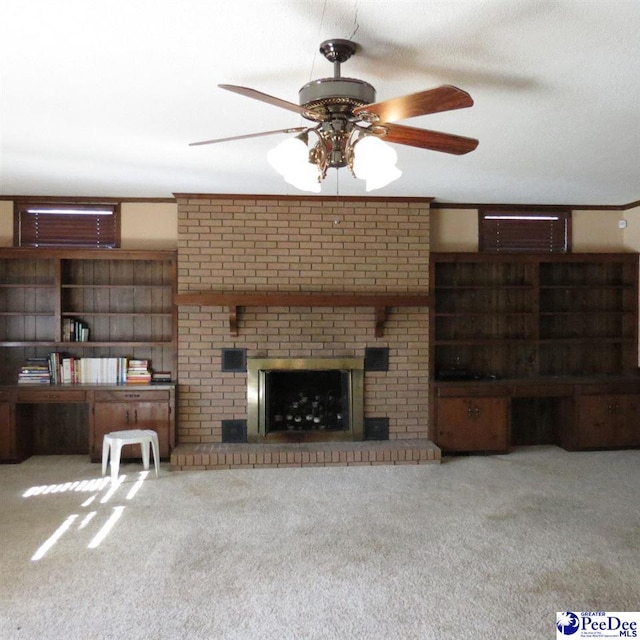 unfurnished living room featuring crown molding, a brick fireplace, light carpet, and built in desk