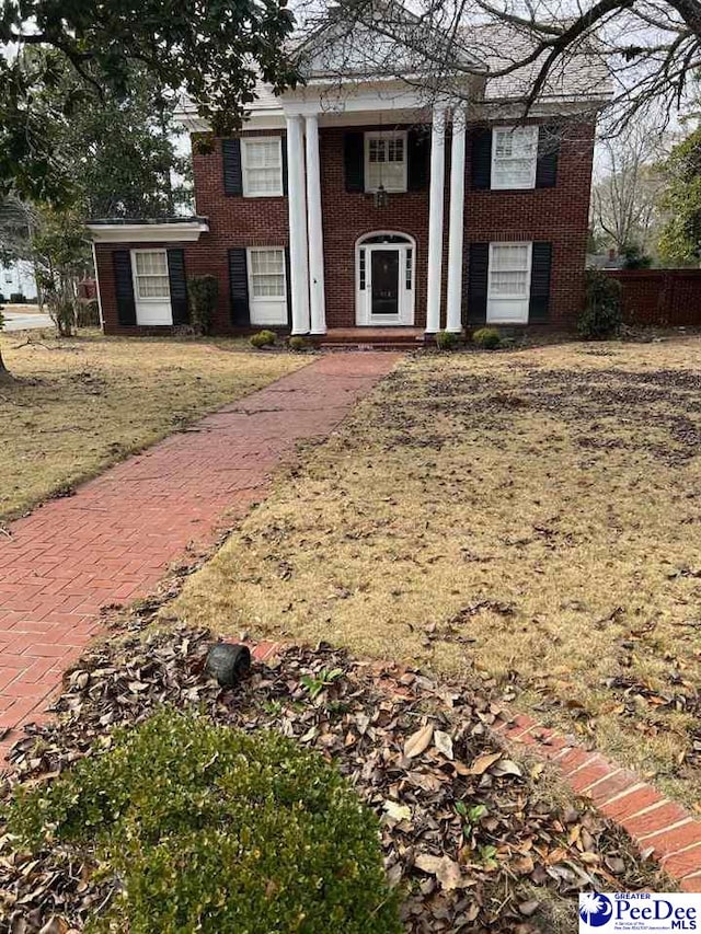 greek revival house featuring a front lawn