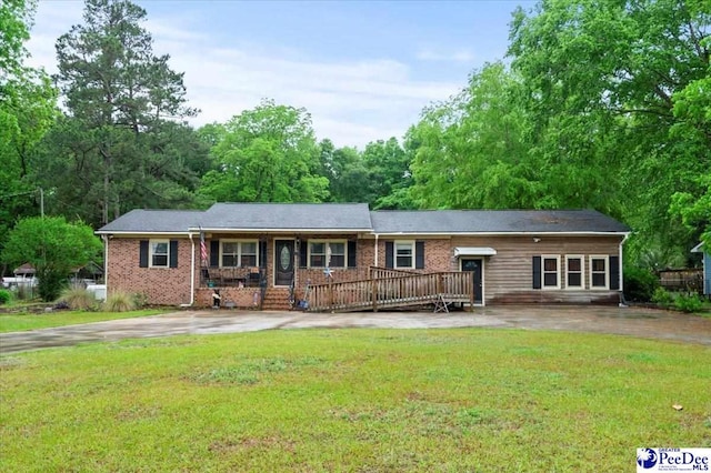 1017 Big Swamp Rd, Pamplico, SC 29583 - ranch-style house with a front yard, a porch, and brick siding