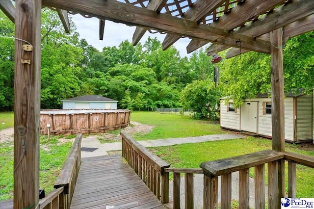 1017 Big Swamp Rd, Pamplico, SC 29583 - view of green lawn with a storage unit, an outbuilding, a pergola, and a wooden deck