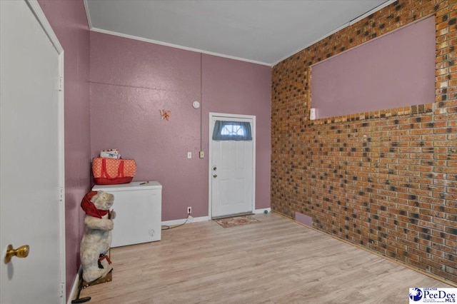 1017 Big Swamp Rd, Pamplico, SC 29583 - foyer with wood finished floors, crown molding, baseboards, and brick wall