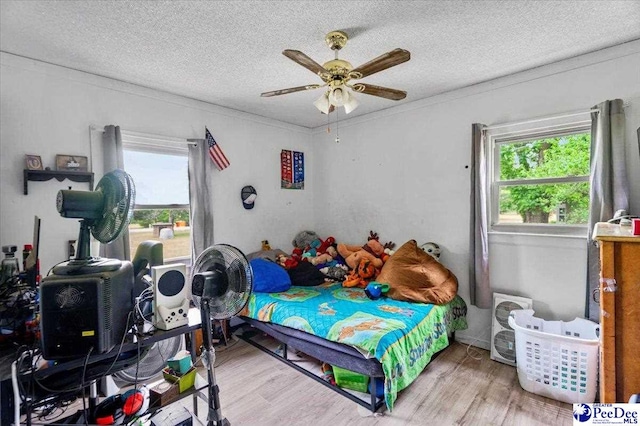 1017 Big Swamp Rd, Pamplico, SC 29583 - bedroom featuring wood finished floors, a textured ceiling, ornamental molding, and a ceiling fan