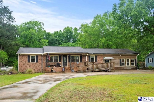 1017 Big Swamp Rd, Pamplico, SC 29583 - ranch-style home with a front yard, concrete driveway, and brick siding