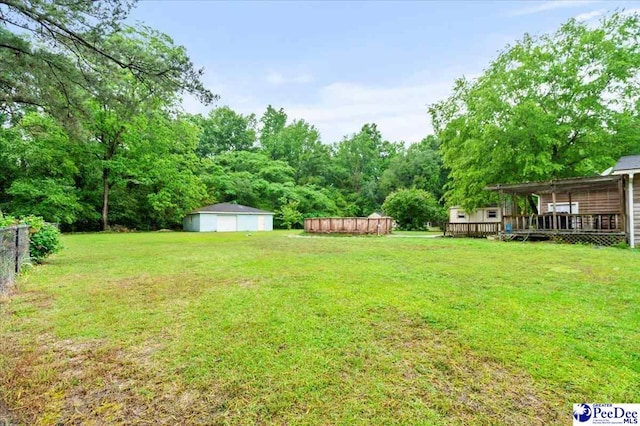 1017 Big Swamp Rd, Pamplico, SC 29583 - view of yard with a garage, a wooden deck, and an outdoor structure