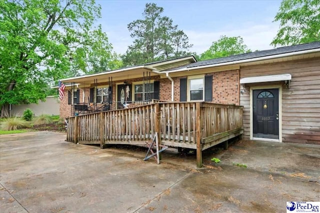 1017 Big Swamp Rd, Pamplico, SC 29583 - rear view of property featuring brick siding and a deck