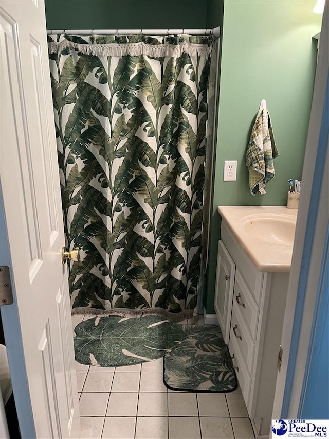 bathroom with vanity, curtained shower, and tile patterned floors