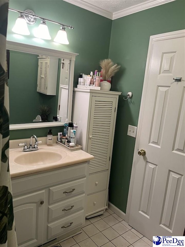 bathroom featuring tile patterned flooring, vanity, ornamental molding, and a textured ceiling