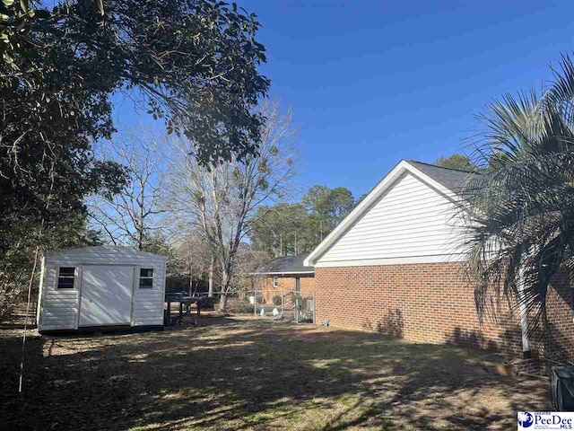 view of side of home with a shed