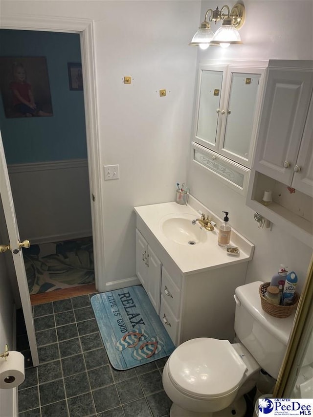 bathroom with tile patterned floors, vanity, and toilet