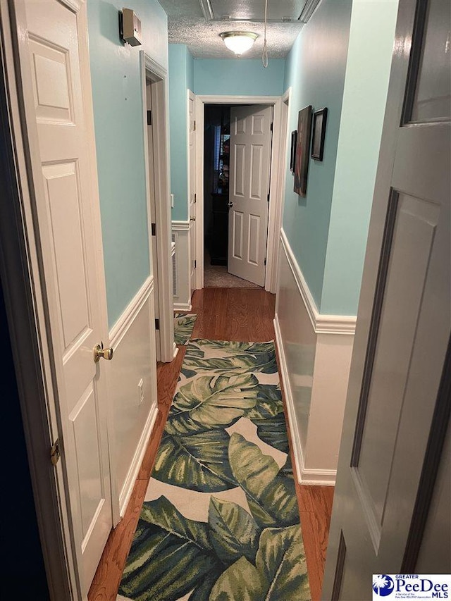 corridor with hardwood / wood-style floors