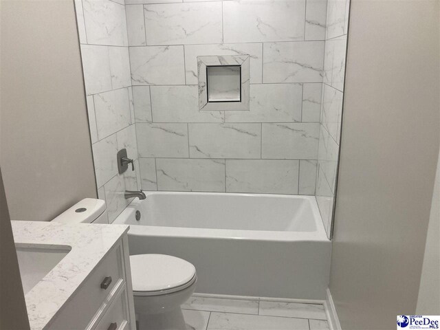 full bathroom with vanity, toilet, and tiled shower / bath combo