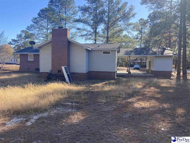 rear view of property featuring a carport