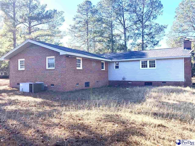 back of house featuring central AC