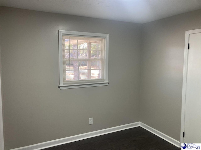 unfurnished room with wood-type flooring