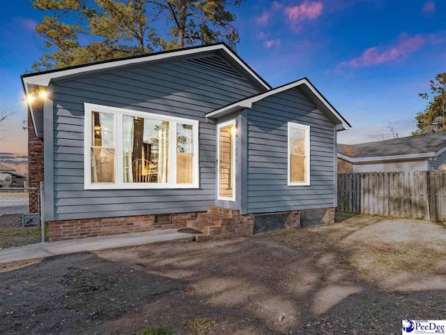 exterior space featuring entry steps, crawl space, and fence