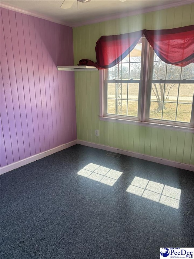 spare room with a healthy amount of sunlight, visible vents, and baseboards