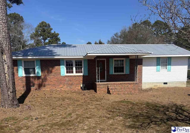 ranch-style home with covered porch, metal roof, brick siding, and crawl space