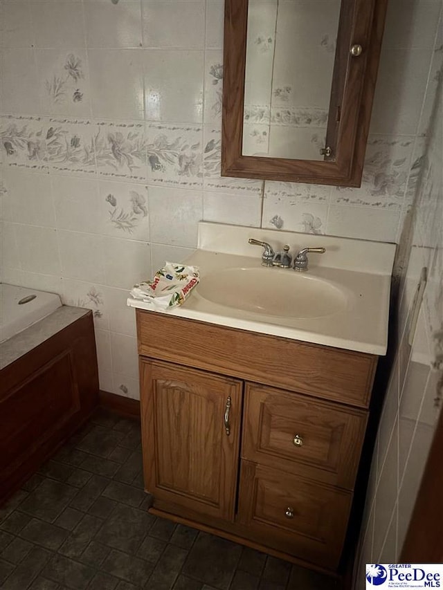 bathroom featuring vanity and tile walls