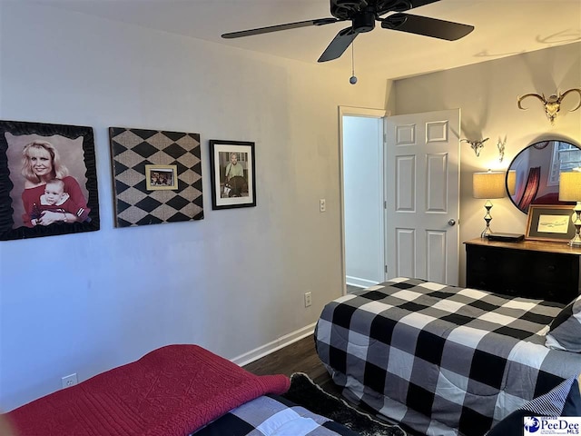 bedroom featuring ceiling fan and dark hardwood / wood-style flooring