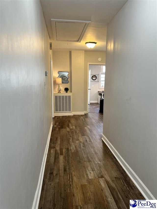 corridor featuring dark hardwood / wood-style flooring