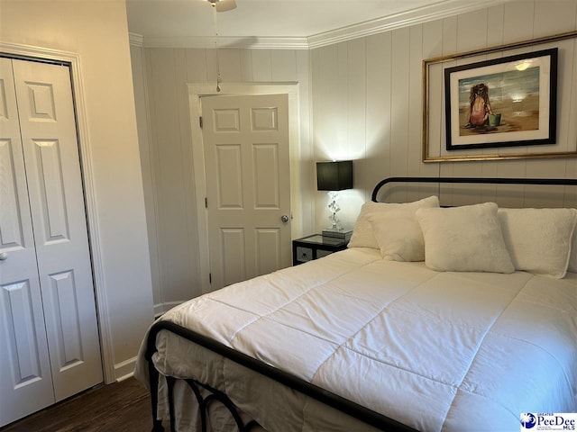 bedroom featuring crown molding and dark hardwood / wood-style floors