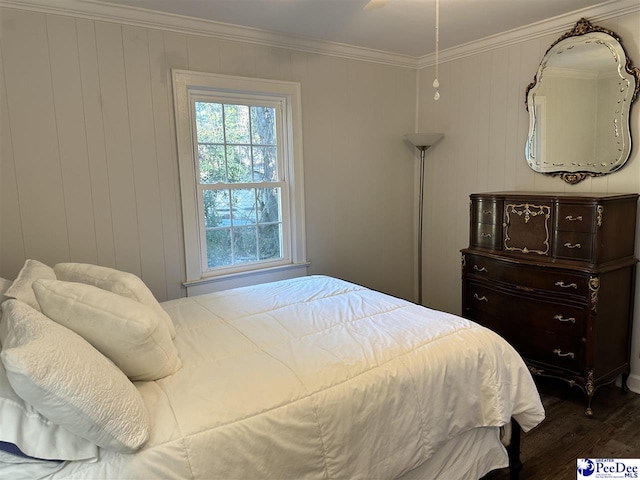 bedroom with crown molding and dark hardwood / wood-style flooring