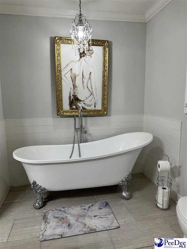 bathroom featuring a tub, tile walls, a chandelier, tile patterned flooring, and crown molding