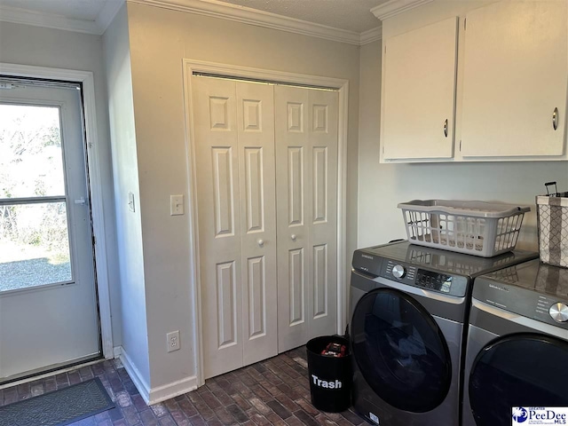 laundry room with a wealth of natural light, ornamental molding, washing machine and dryer, and cabinets