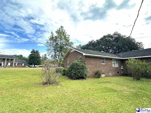 view of side of property with a yard