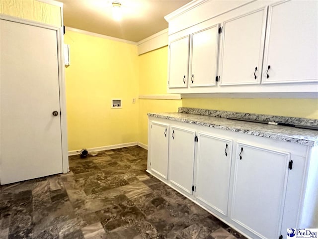 clothes washing area featuring cabinets, ornamental molding, and hookup for a washing machine